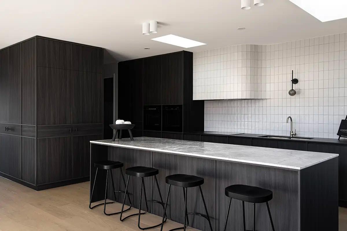 Project Ward 2.0 (Dark timber island with marble benchtop, matching cabinetry and curved white rangehood)
