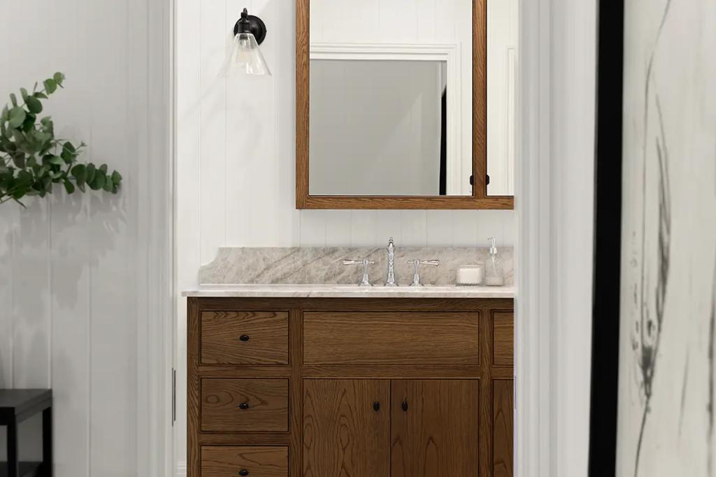 Project Franklin (Compact bathroom vanity with a marble countertop, wood cabinetry, and a matching framed mirror above.)