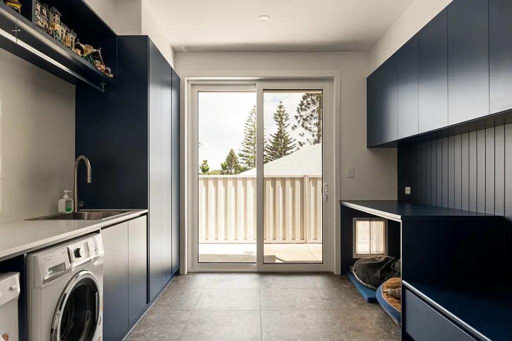 Cheltenham (Laundry with navy cabinetry, washer, and pet nook)