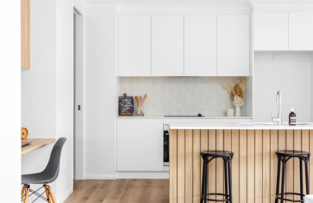 McGrory (White kitchen with light timber-slat island, grey tile splashback and built-in study nook)