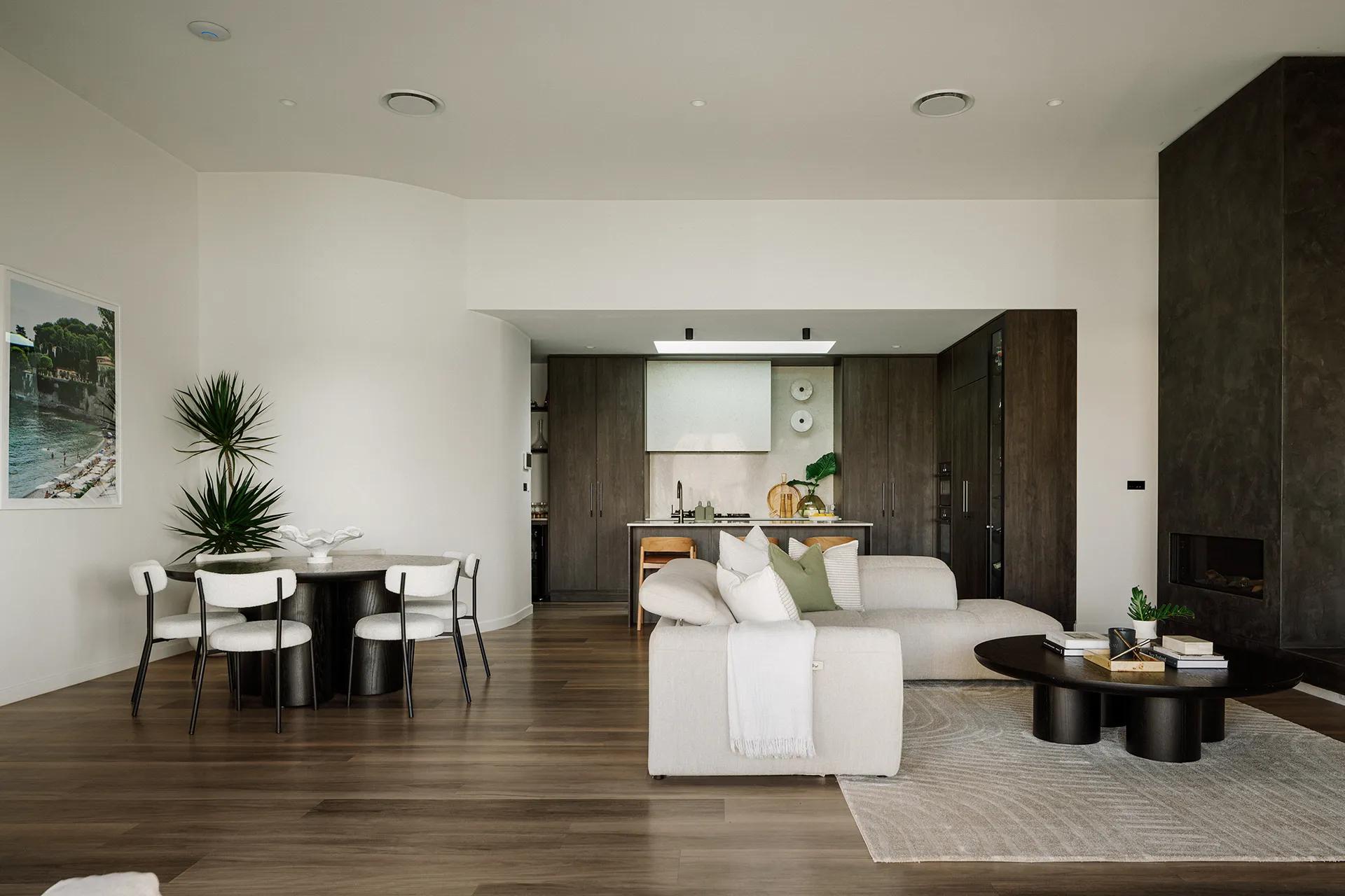Lavish Morada (Open-plan living space with cream sofa, dark timber dining setting and kitchen beyond)