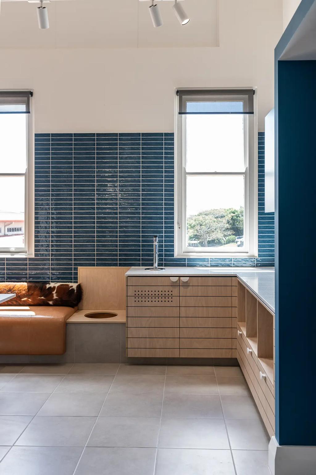 Downlands College Toowoomba Refurbishment (Cozy kitchenette with light wood cabinets, a built-in bench with cowhide cushion, and blue tiled wall.)