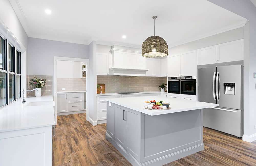 Project Flagstone (White shaker kitchen with grey island, woven pendant and stacked wall ovens)
