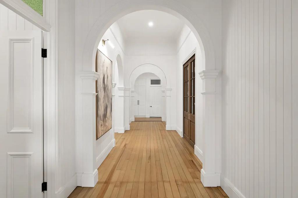 Project Franklin (White arched hallway with timber floors and detailed mouldings.)