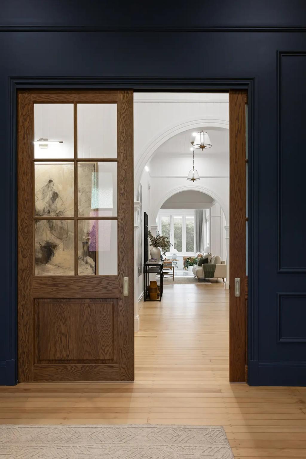 Project Franklin (View through glass-panelled doors to arched hallway and lounge.)