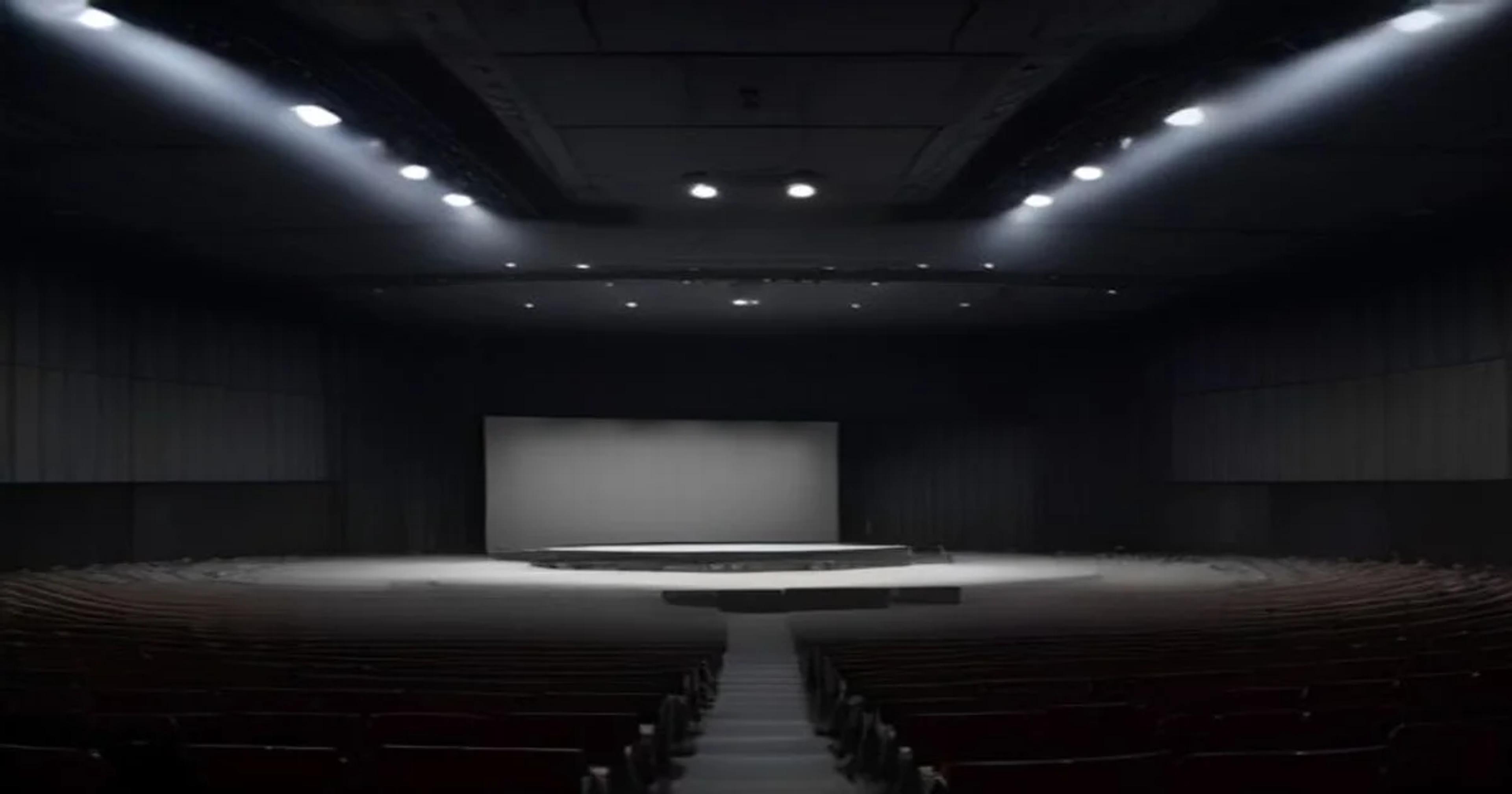 A high-tech concert hall interior utilizing adaptive AI-controlled panels for perfect sound diffusion.