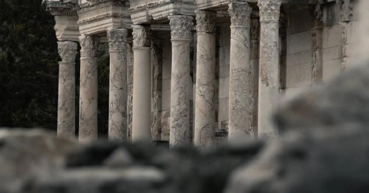 An architectural monument being reconstructed through glowing digital projection mapping.