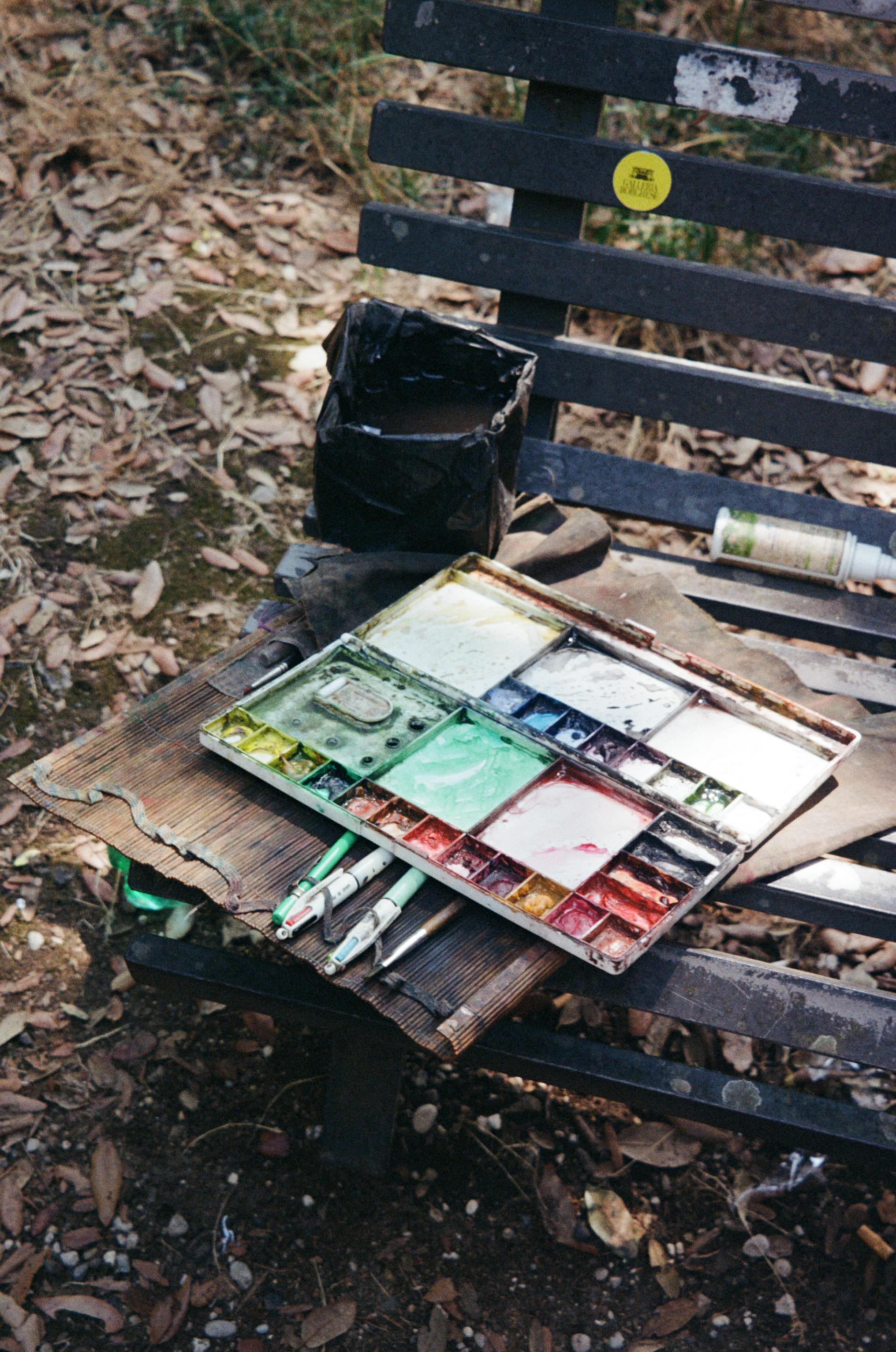 Art supplies on a bench in Villa Borghese gardens.