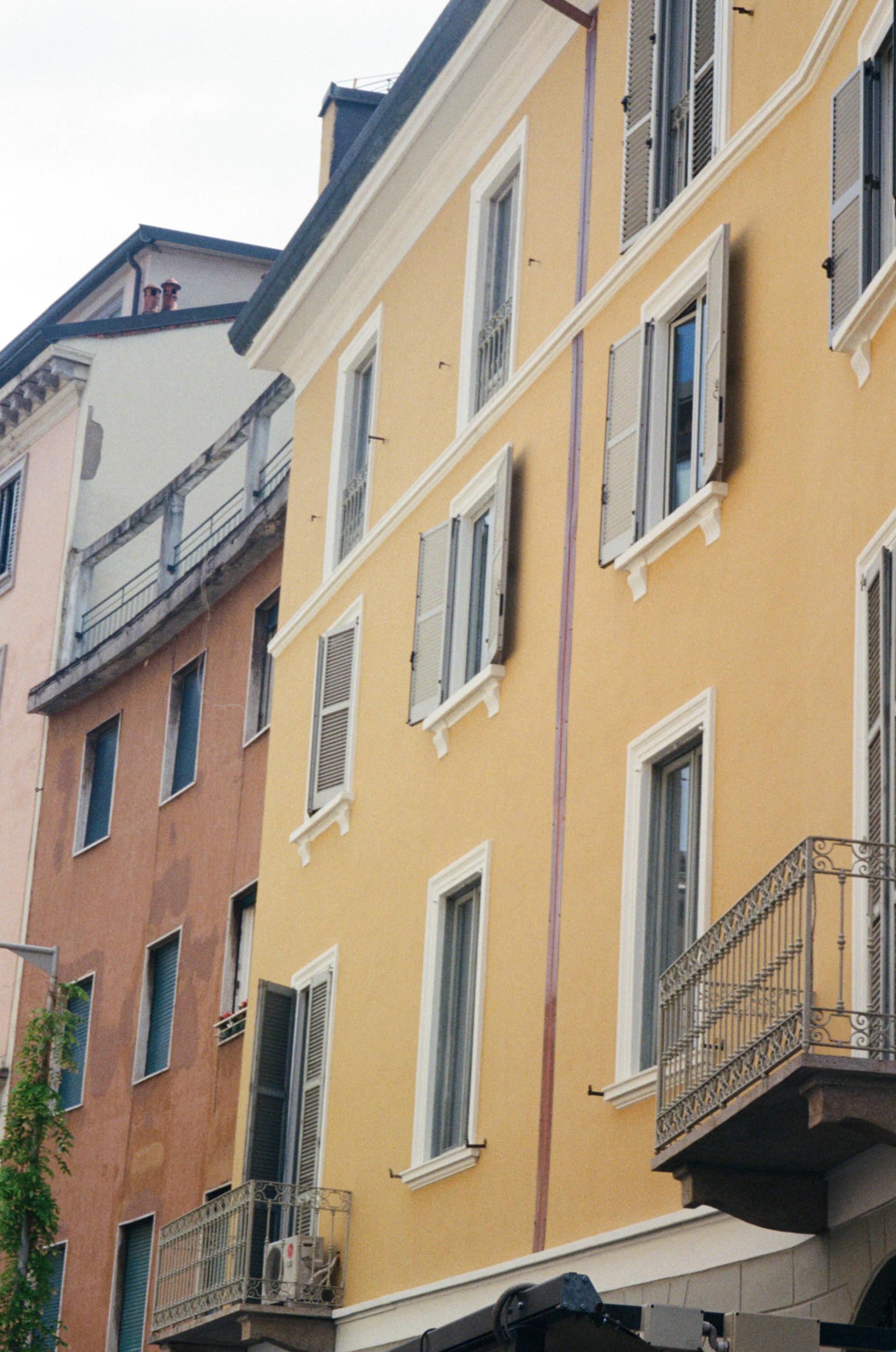 Yellow, terracotta, and pink building facades in Milan.