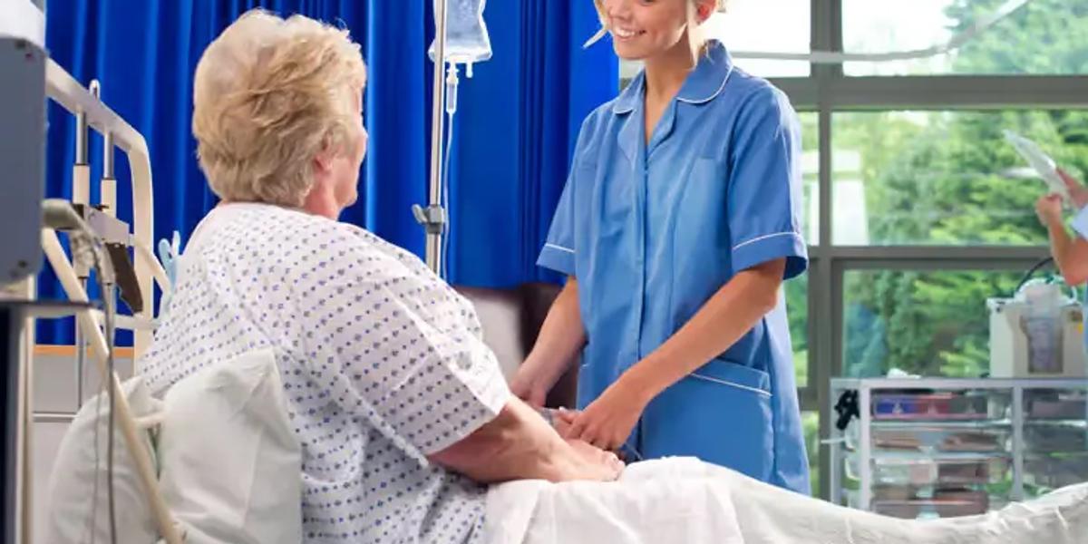 Professional nurse assisting a patient with breathing exercises and post-surgery care at home in Chennai.