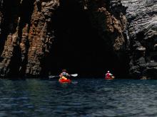 Discover dramatic cliffs and hidden sea caves by kayak