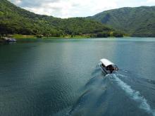 Cruise across Piva Lake’s crystal-clear waters