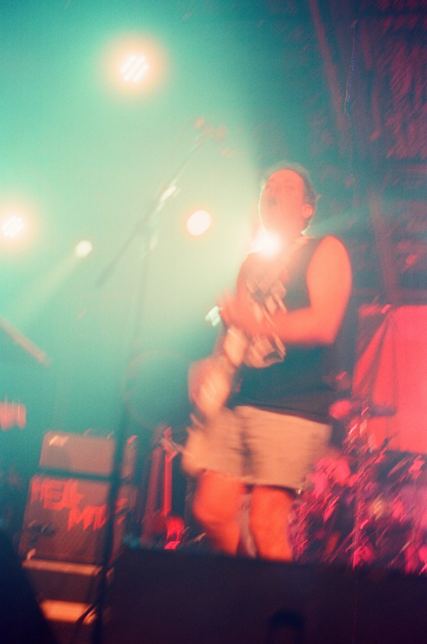 a blurry photo of a man playing a guitar on stage