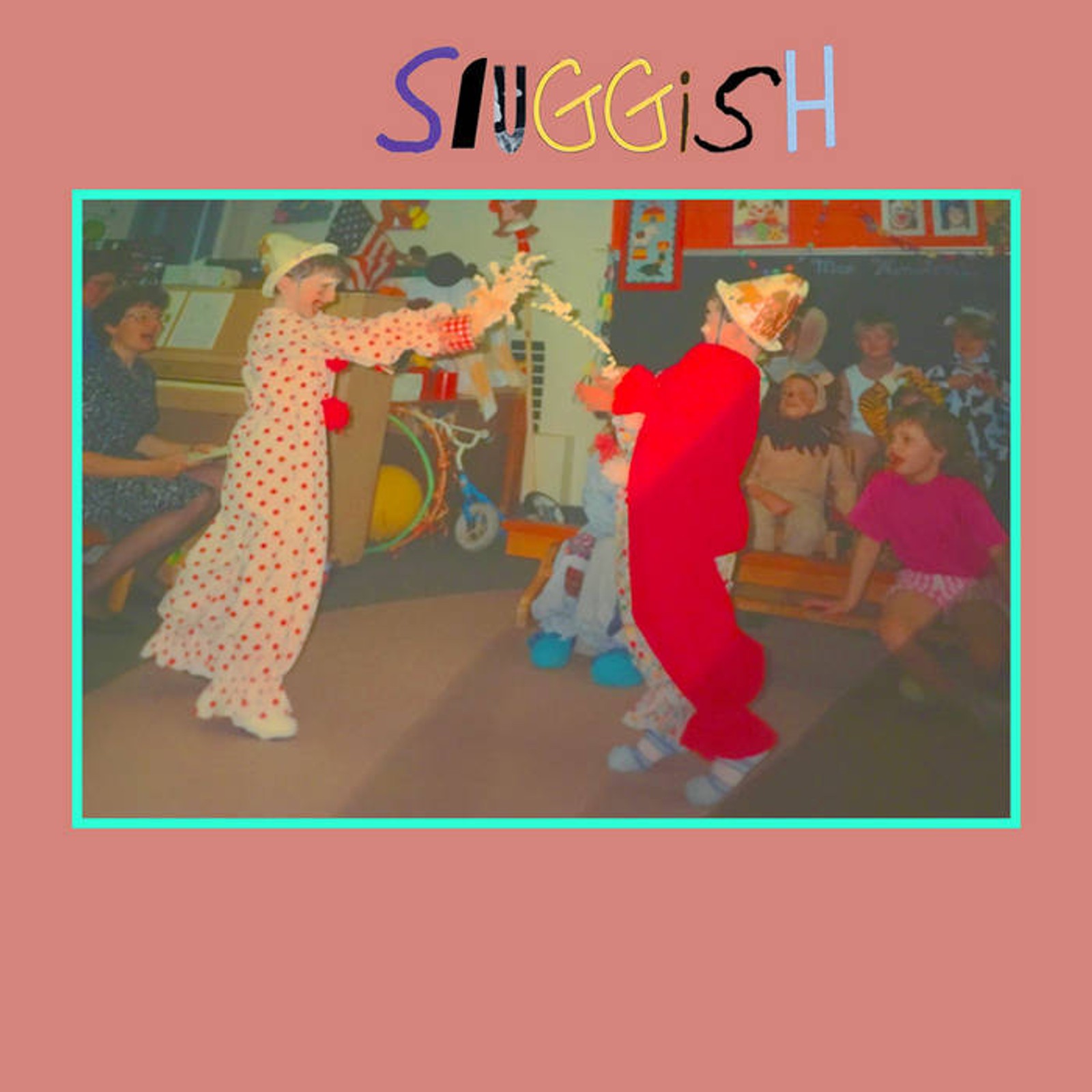 two clowns are dancing in front of a group of children in a room .