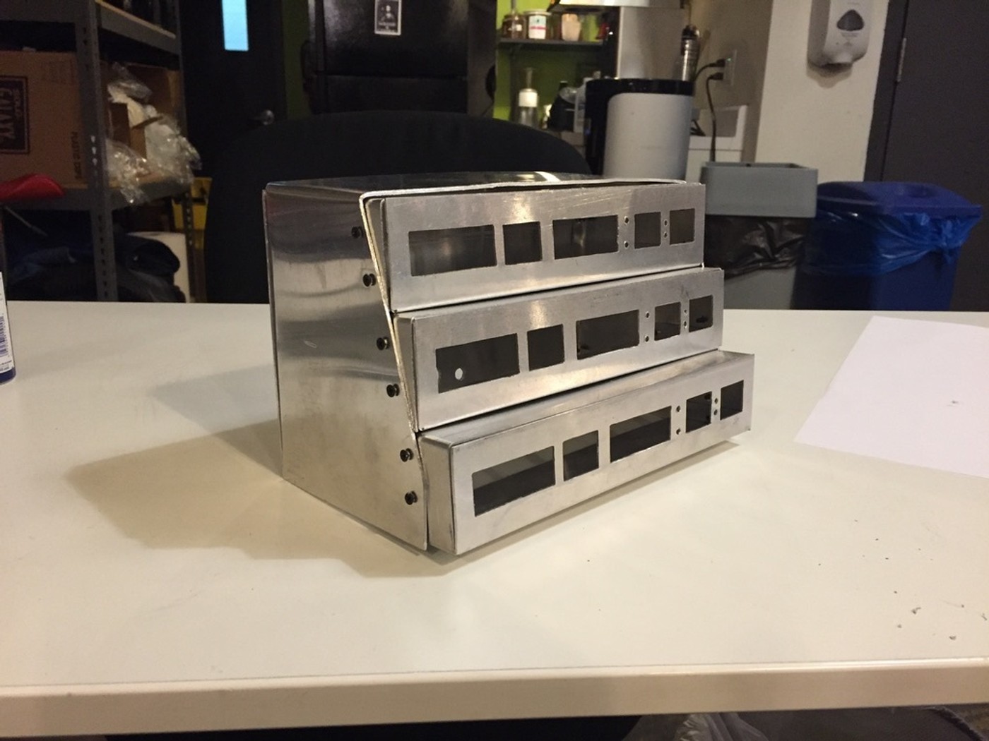 a stack of metal boxes sitting on top of a white table .