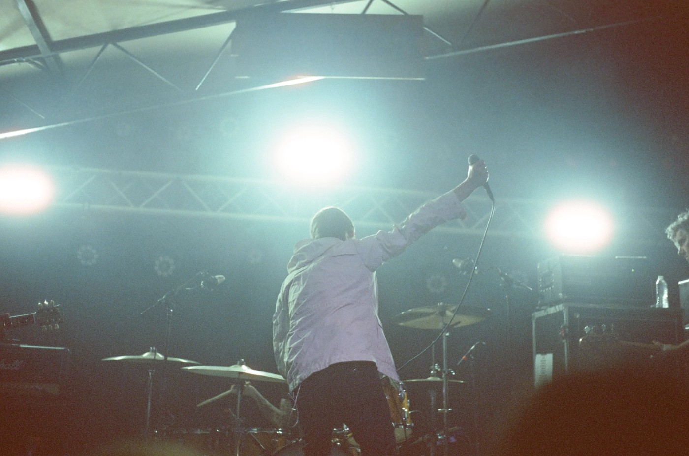 a man is singing into a microphone on a stage .