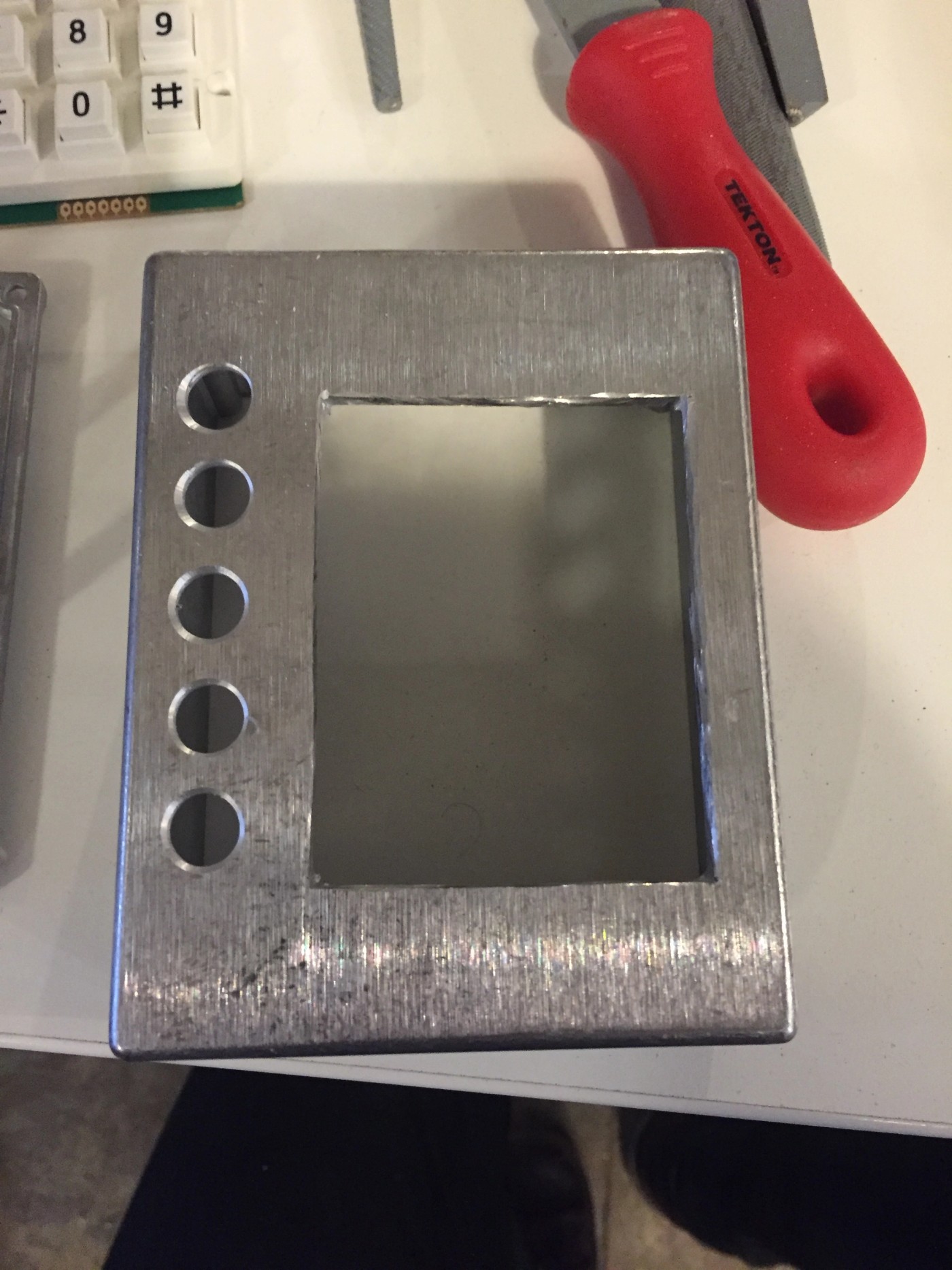 A metal box, drilled out for electronics