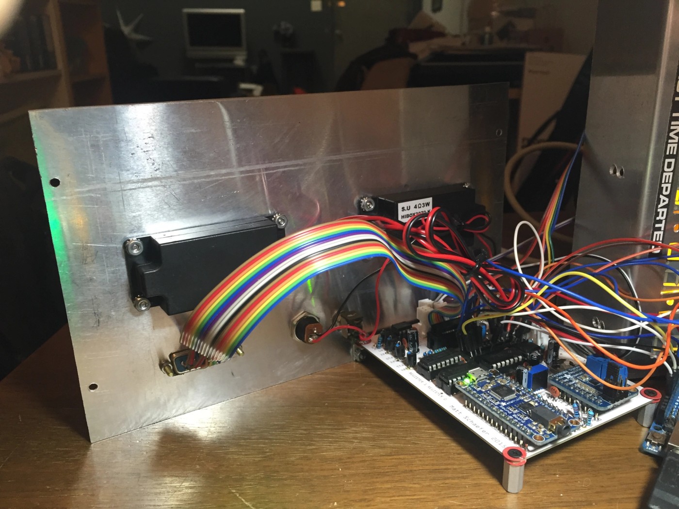 a bunch of wires are connected to a motherboard on a wooden table .