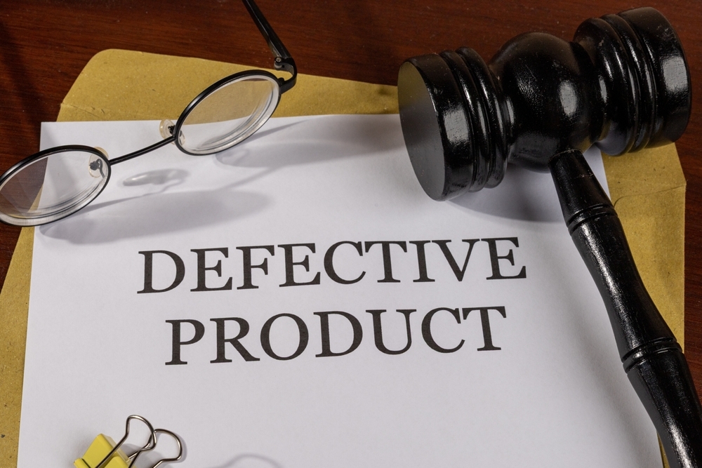 Image Gavel, glasses, and a document labeled defective product, representing a Philadelphia wrongful death claim involving a dangerous product.