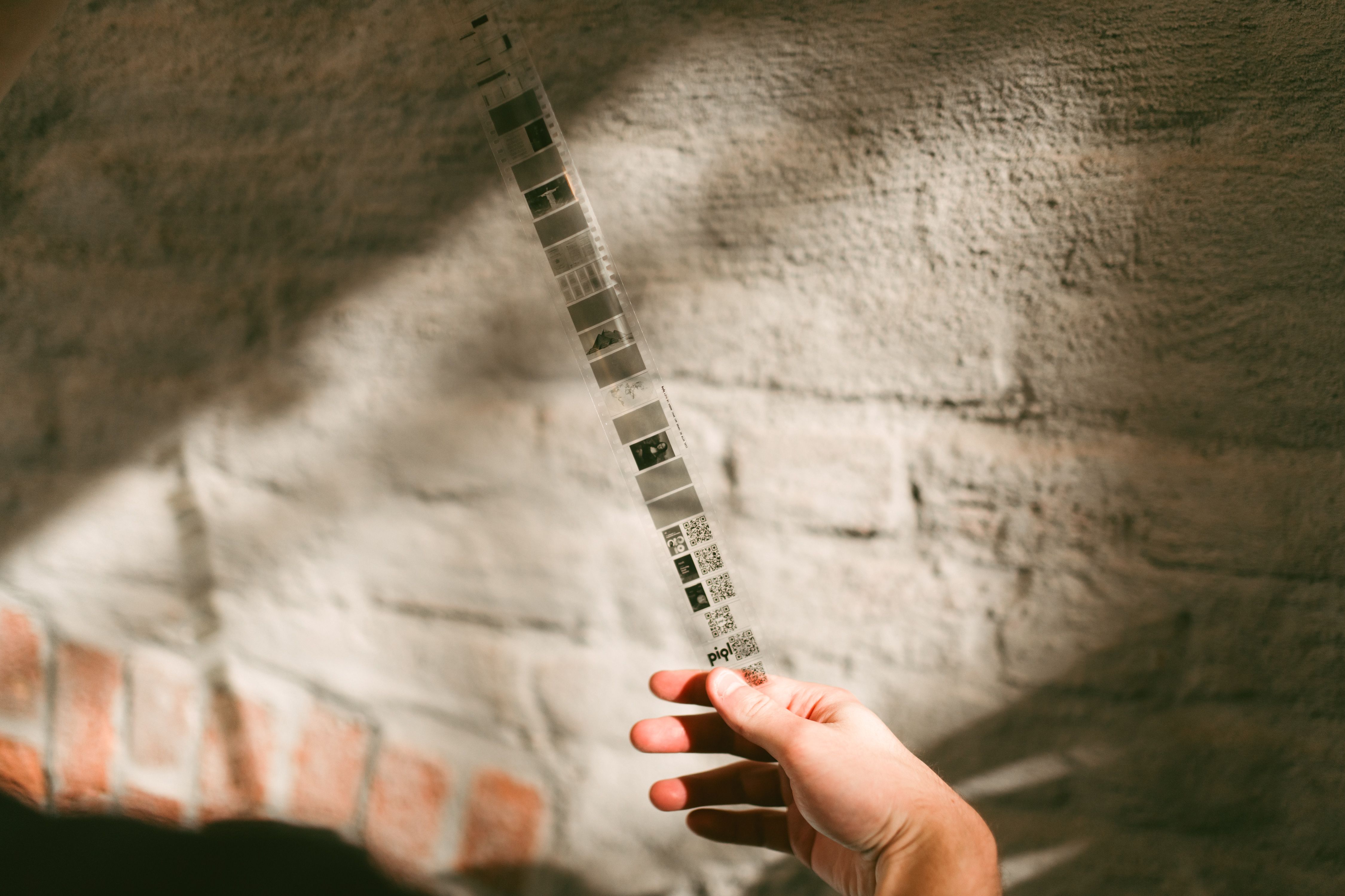 A man holding a 35mm film strip.