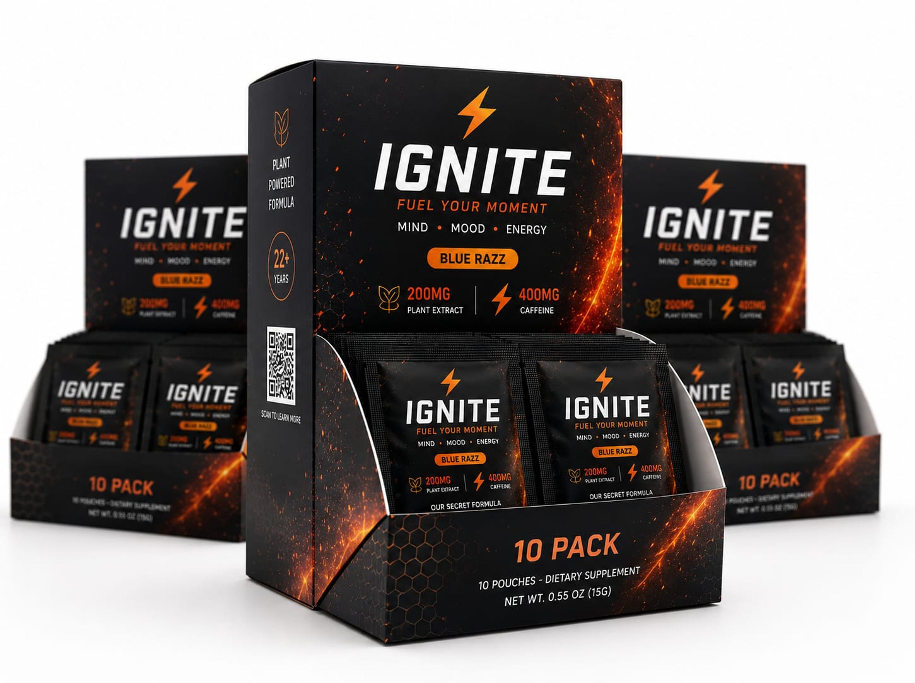 A black and orange energy-supplement retail display box holding single-serve sachets, with two more boxes behind on a white background.