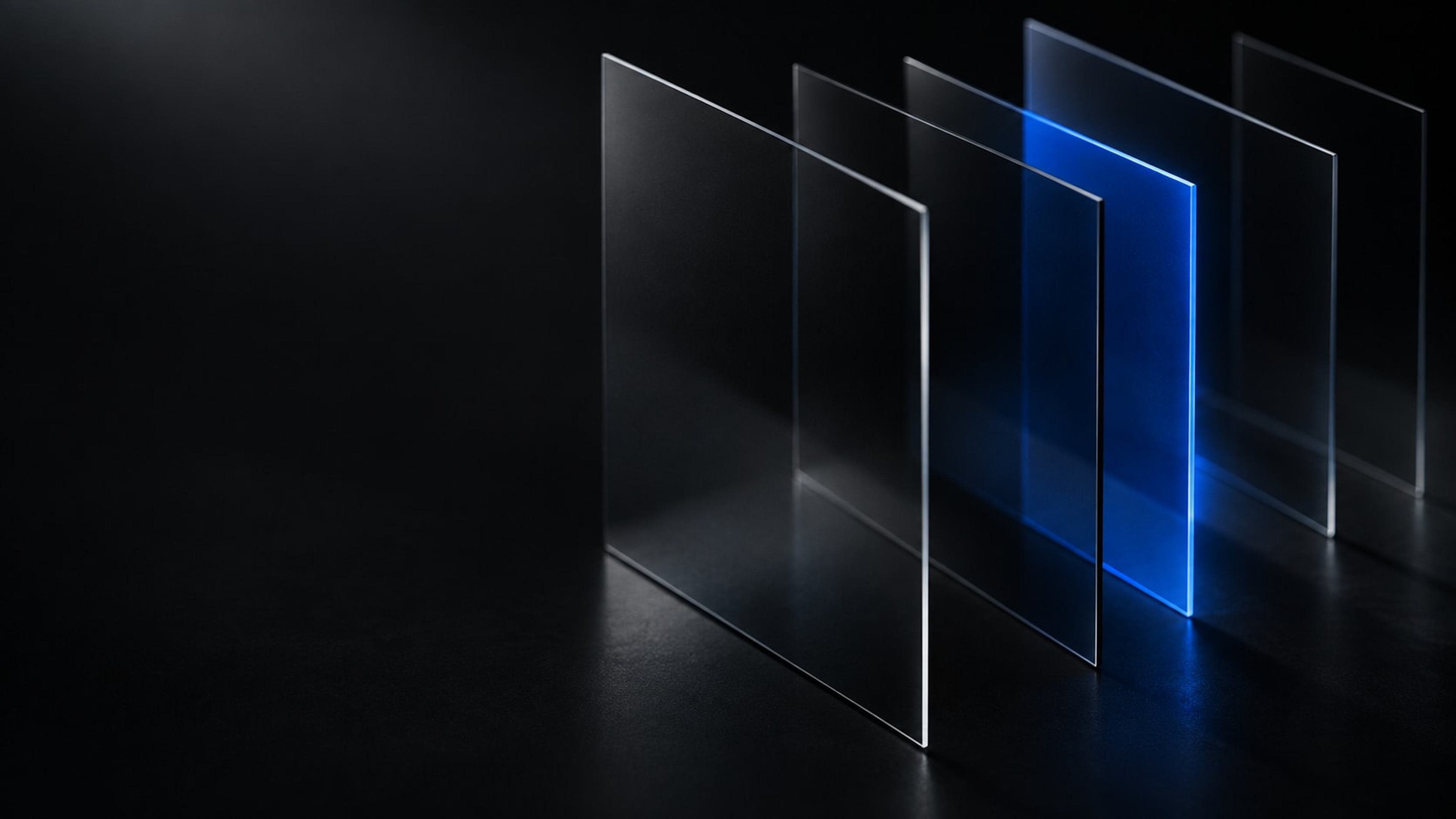 Five upright panes of dark glass receding into black, one of them lit blue: a single layer switched on inside a stack that otherwise looks unchanged.