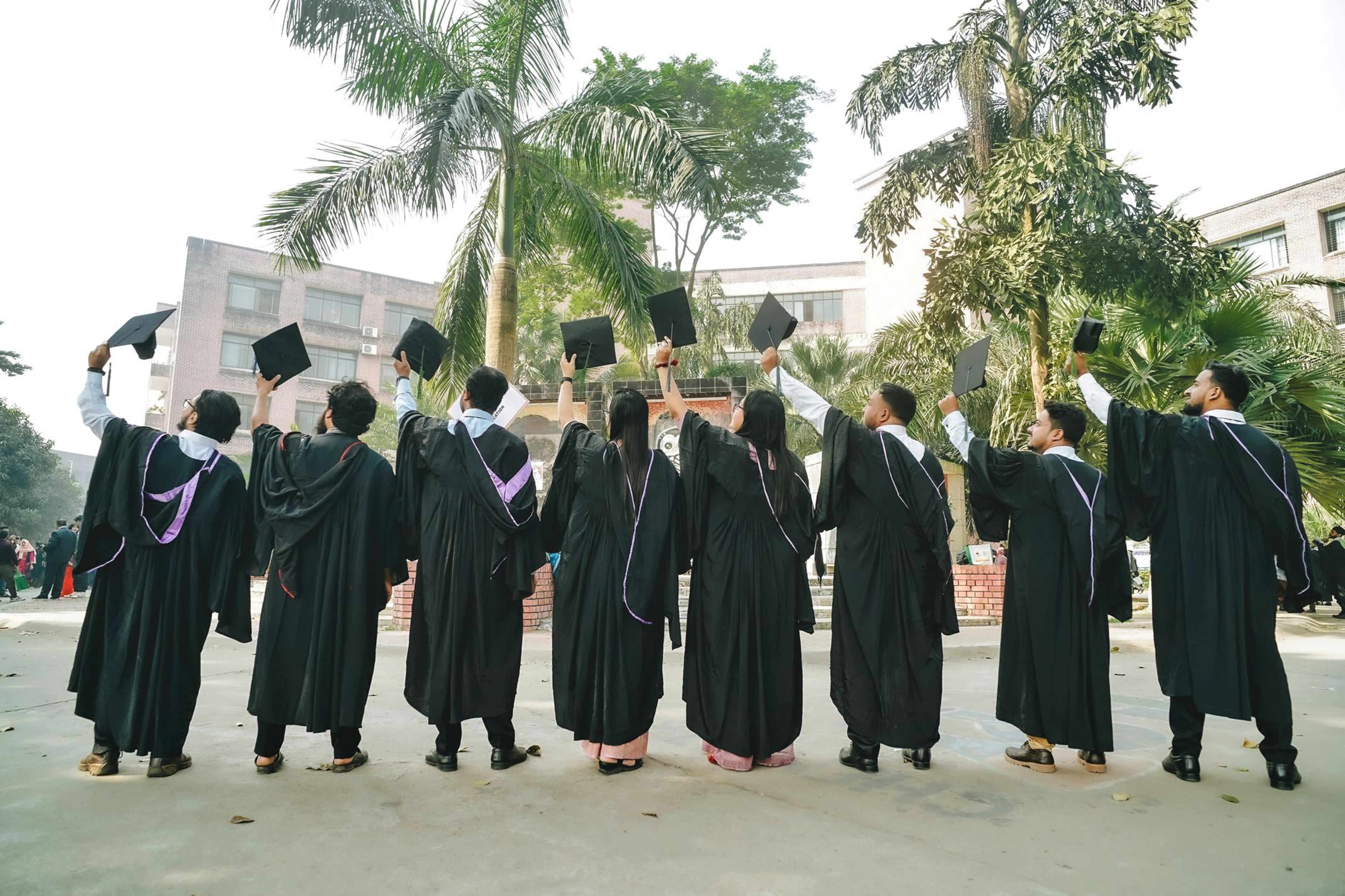 Graduates celebrating on campus, caps in the air — Noida-based education institute, Delhi NCR · Webzenia SEO case study