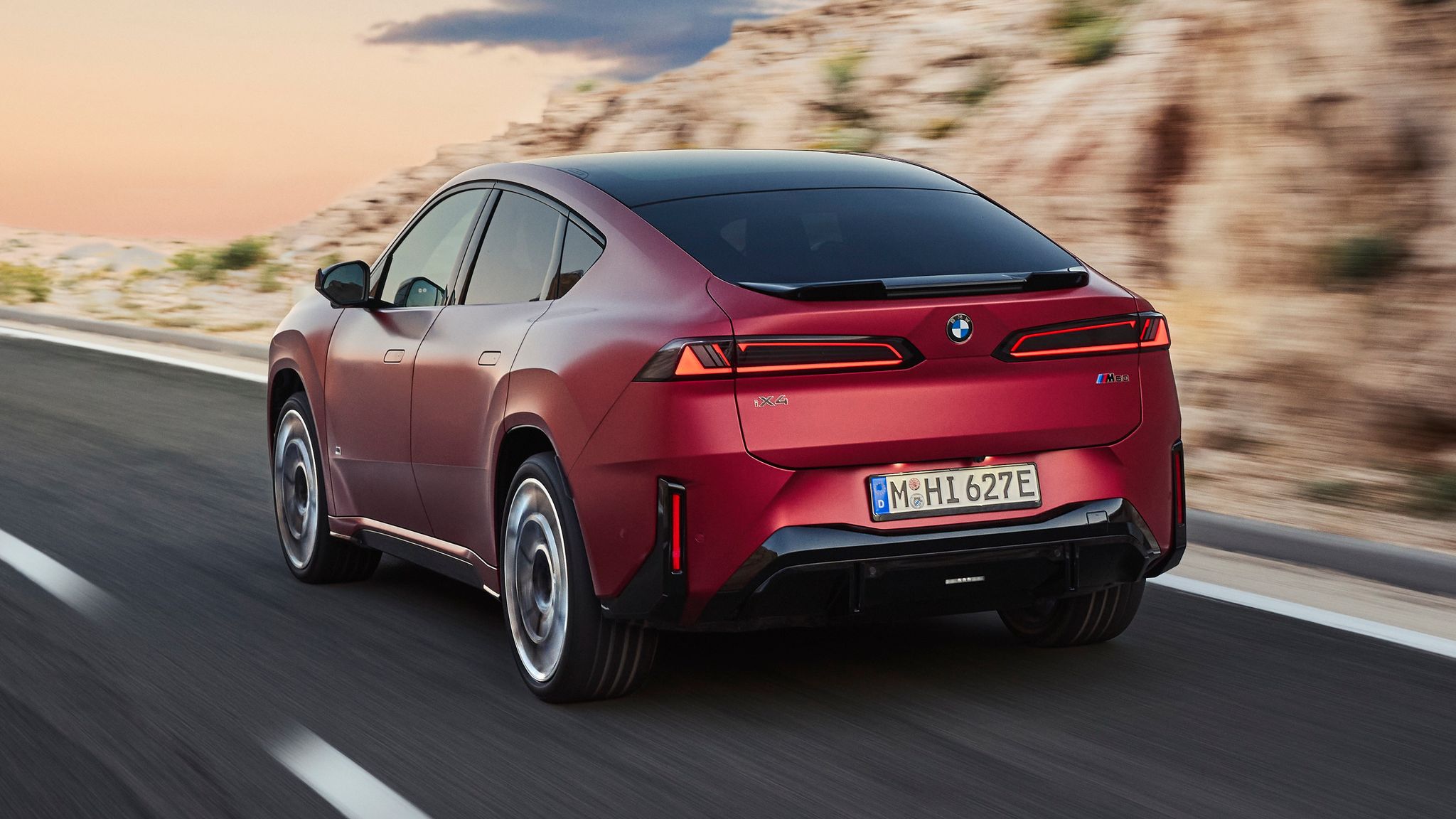 BMW iX4 electric coupe SUV rear three quarter