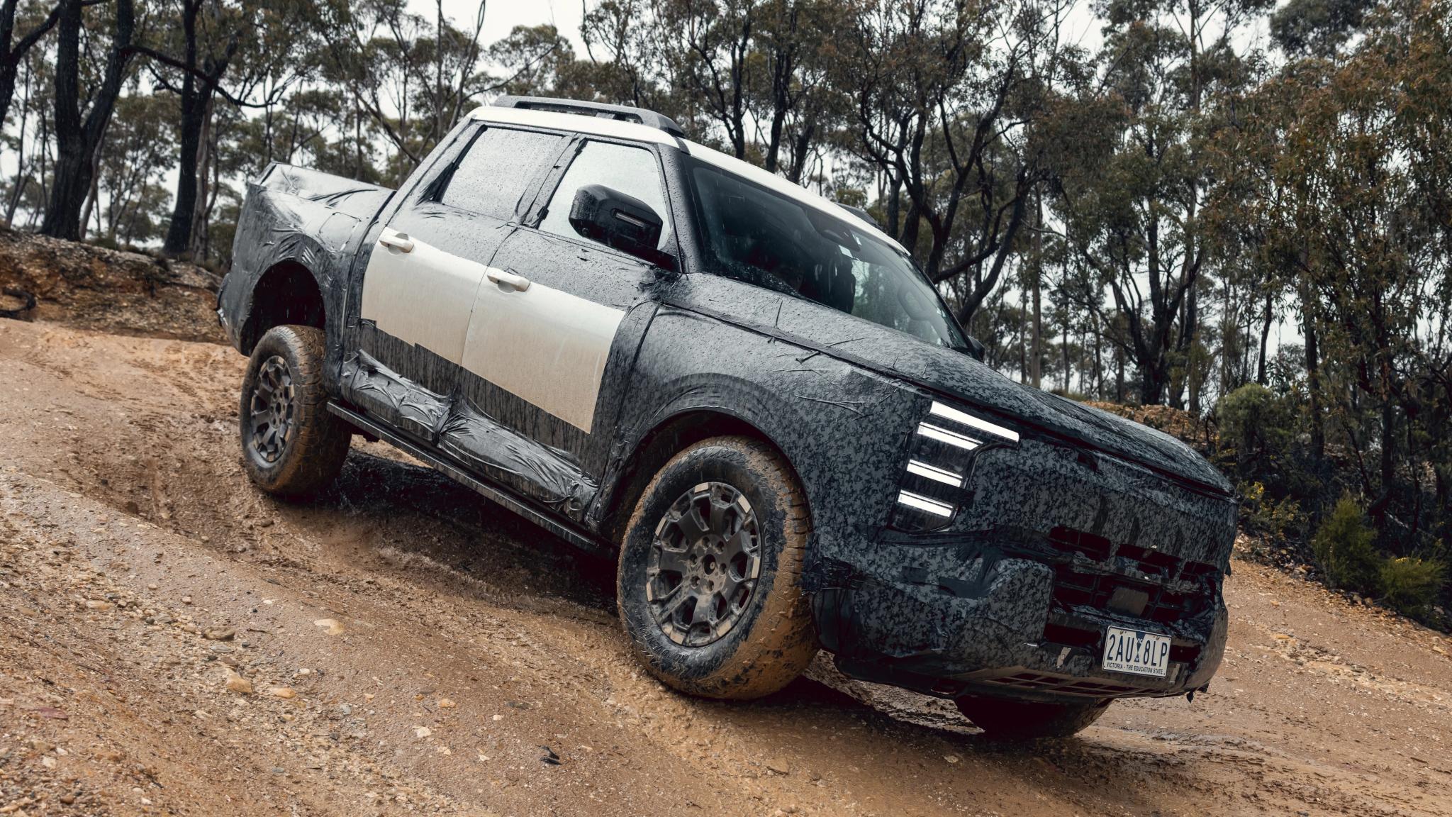 Camouflaged Nissan Navara Pro PHEV prototype dual-cab ute
