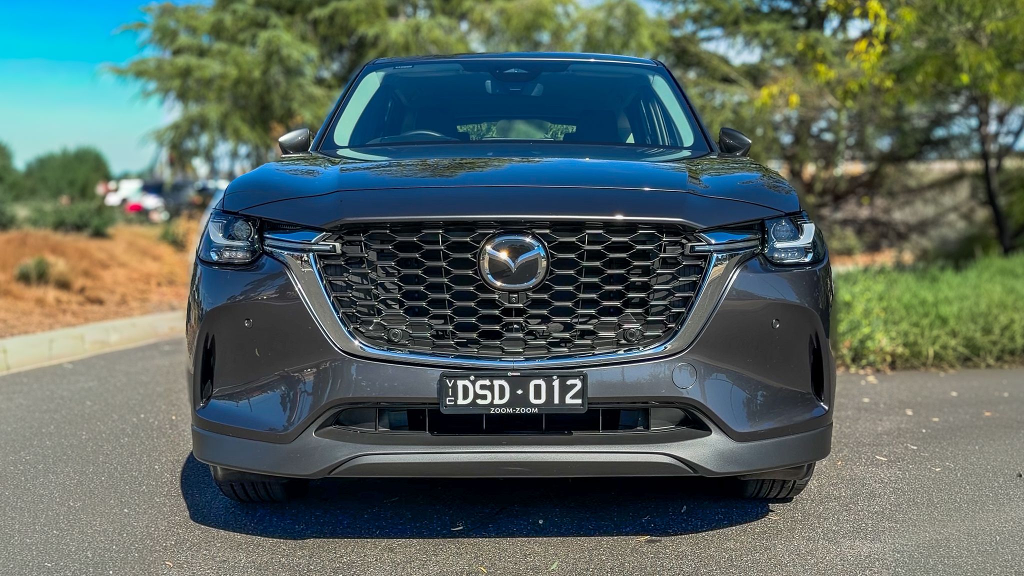 2026 Mazda CX-60 P50e plug-in hybrid in Polymetal Grey Metallic, three-quarter front view on Australian road