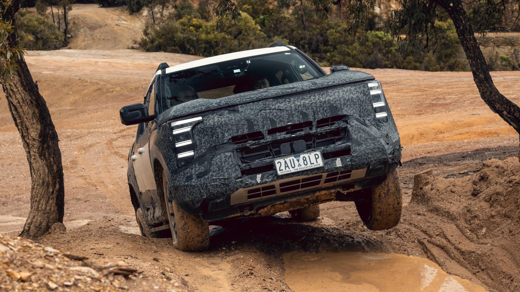 Camouflaged Nissan Navara Pro PHEV prototype dual-cab ute