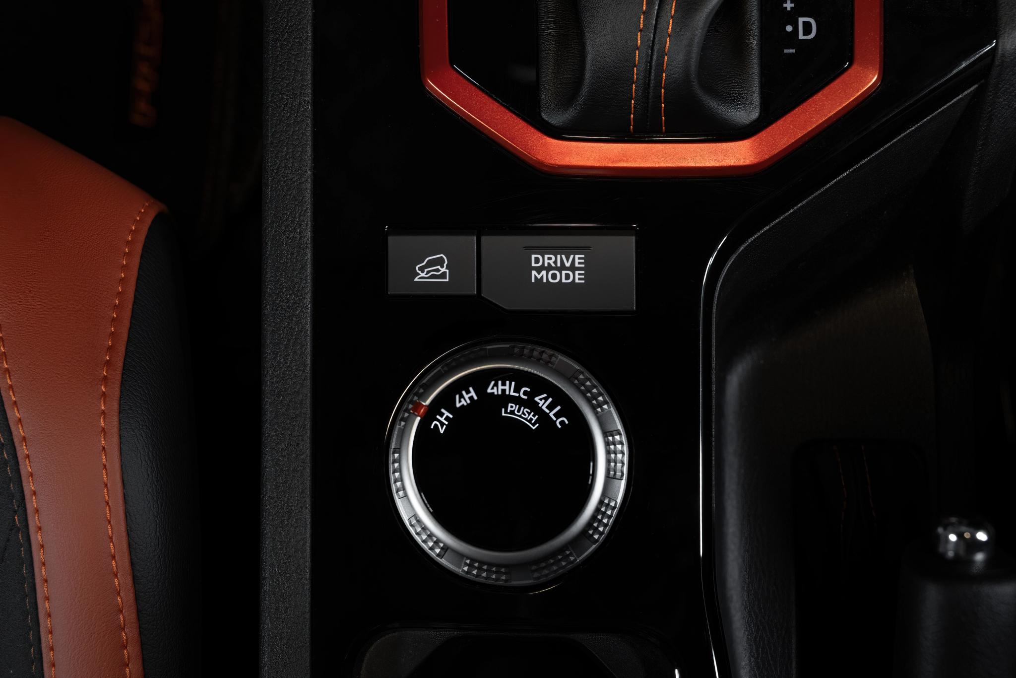 2026 Nissan Navara PRO-4X dual cab ute in Kimberley Orange driving on Australian dirt road