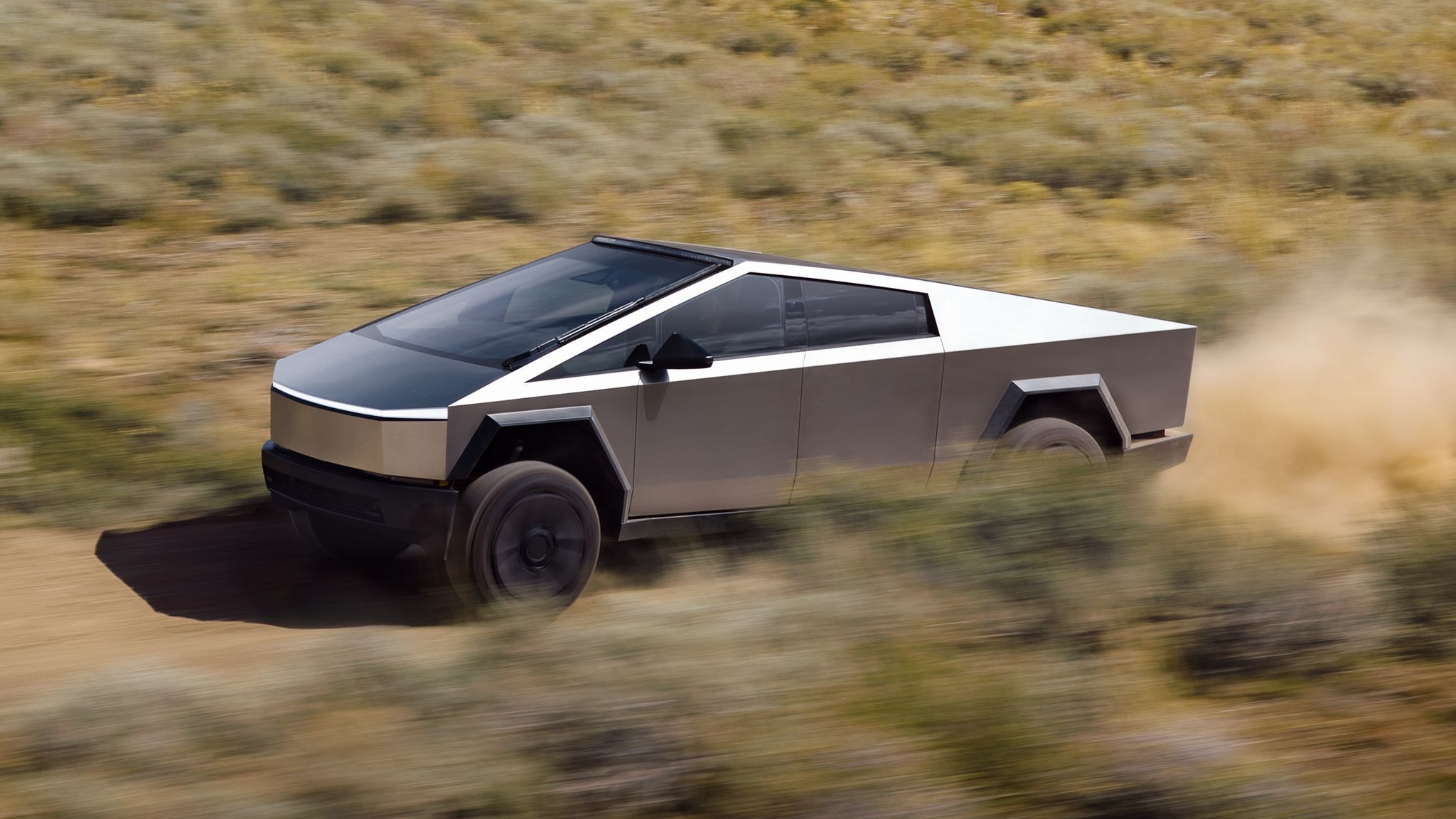Tesla Cybertruck electric ute driving on dirt road