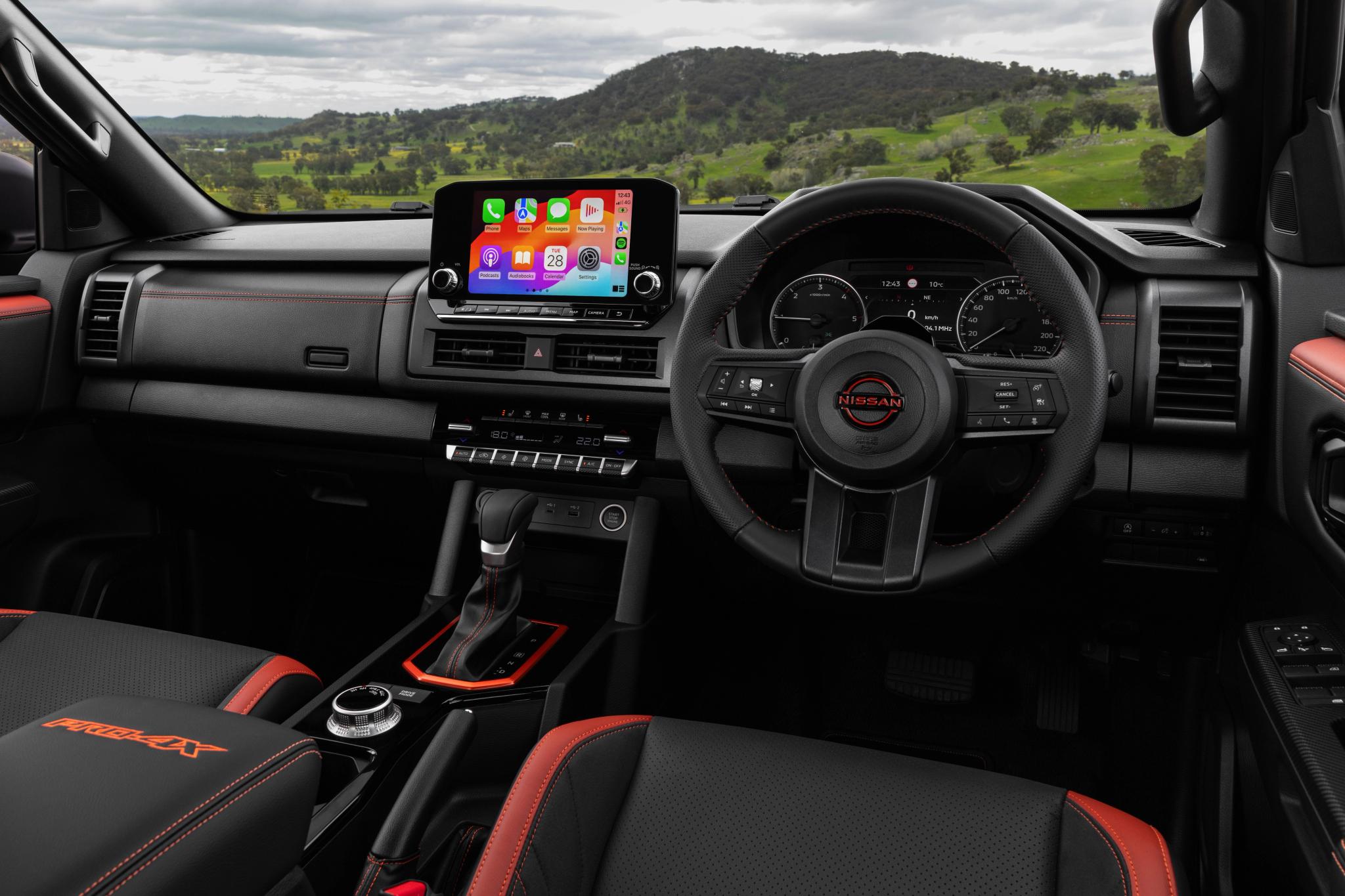 2026 Nissan Navara PRO-4X dual cab ute in Kimberley Orange driving on Australian dirt road
