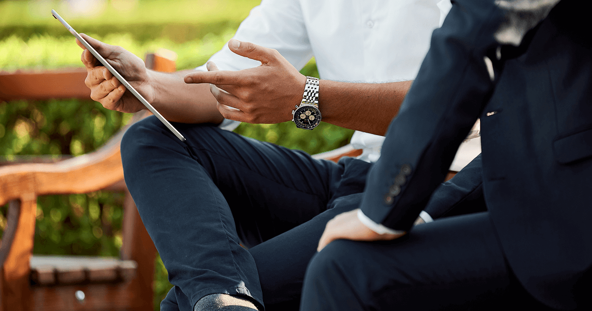 Two people sitting outside reviewing car details