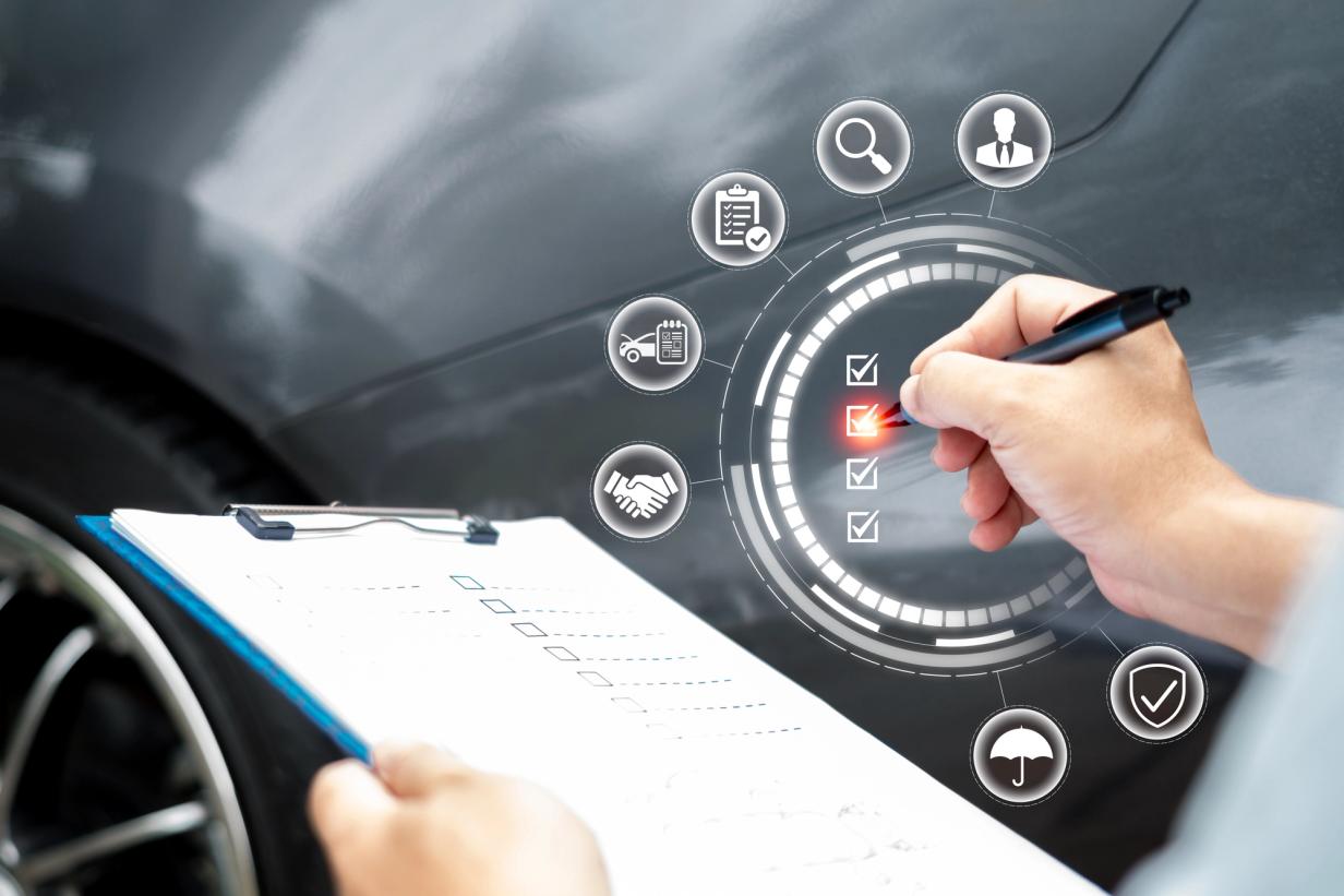 Car buyer using a detailed inspection checklist next to a vehicle before test driving a new or used car