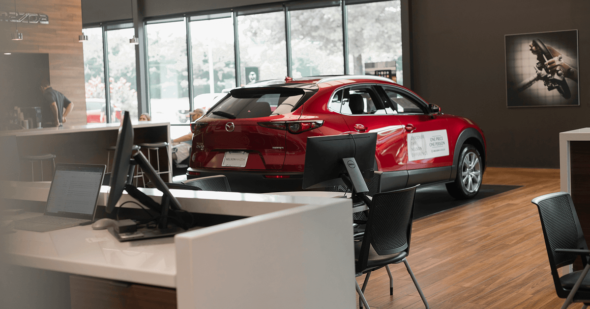 Red Mazda SUV displayed inside a dealership showroom