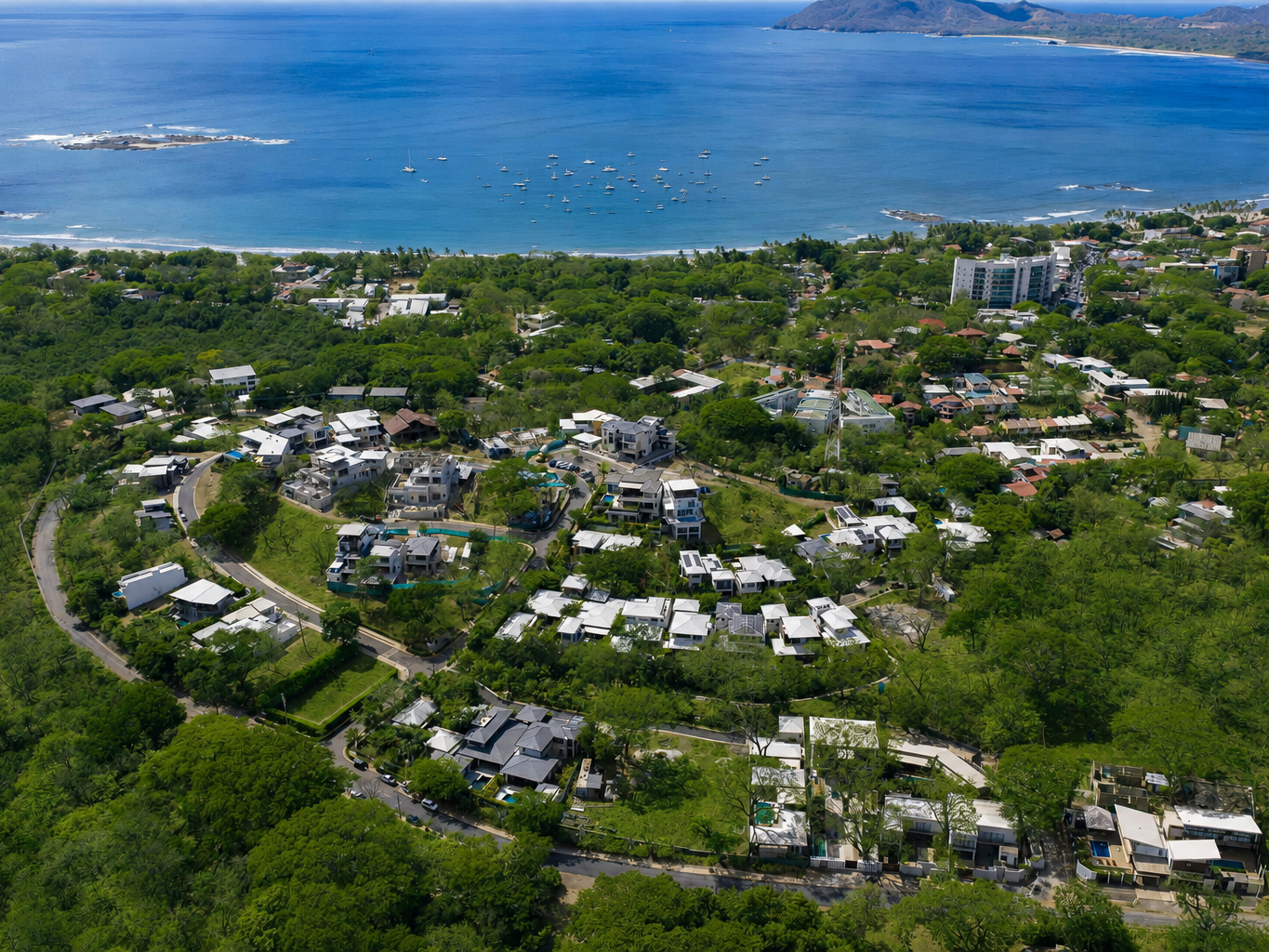 Aerial view of Tamarindo Park homes with standing-seam roofs, solar panels and private pools