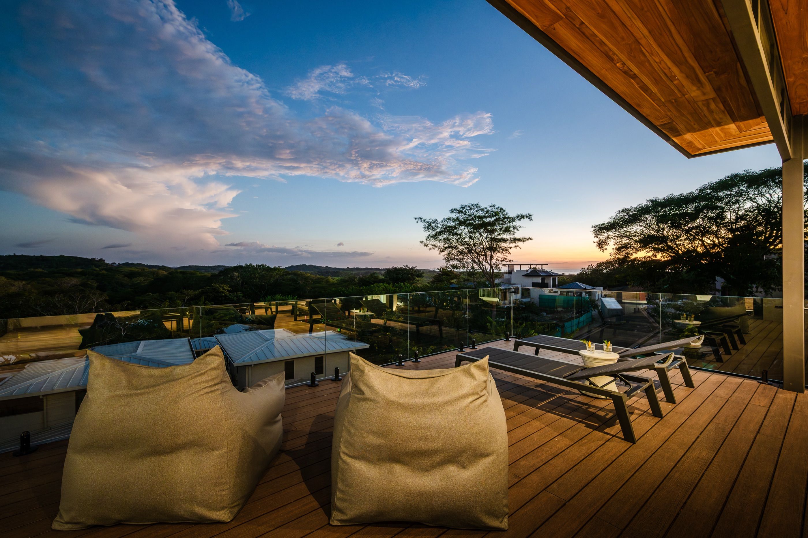 Rooftop terrace with floor cushions overlooking the Guanacaste treeline at dusk