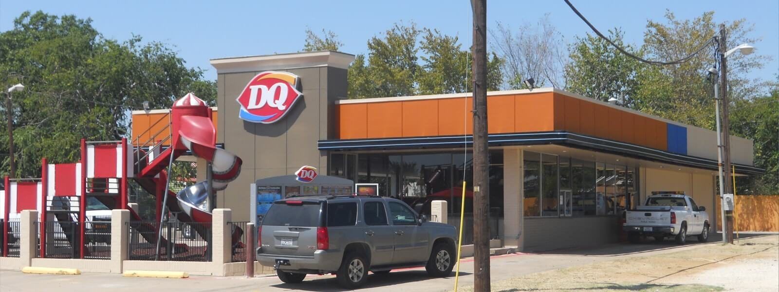 Rebuilt fast food restaurant storefront with a new orange canopy