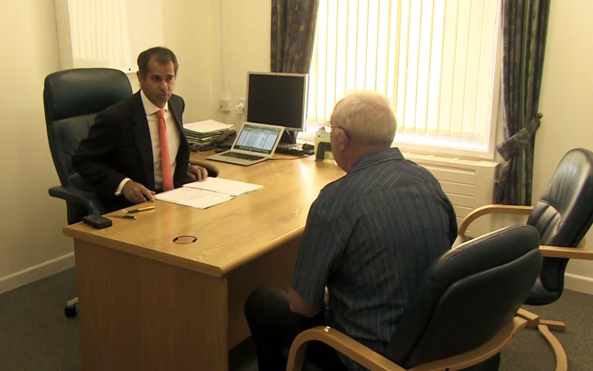 Professor Christopher Eden consults with a patient before surgery