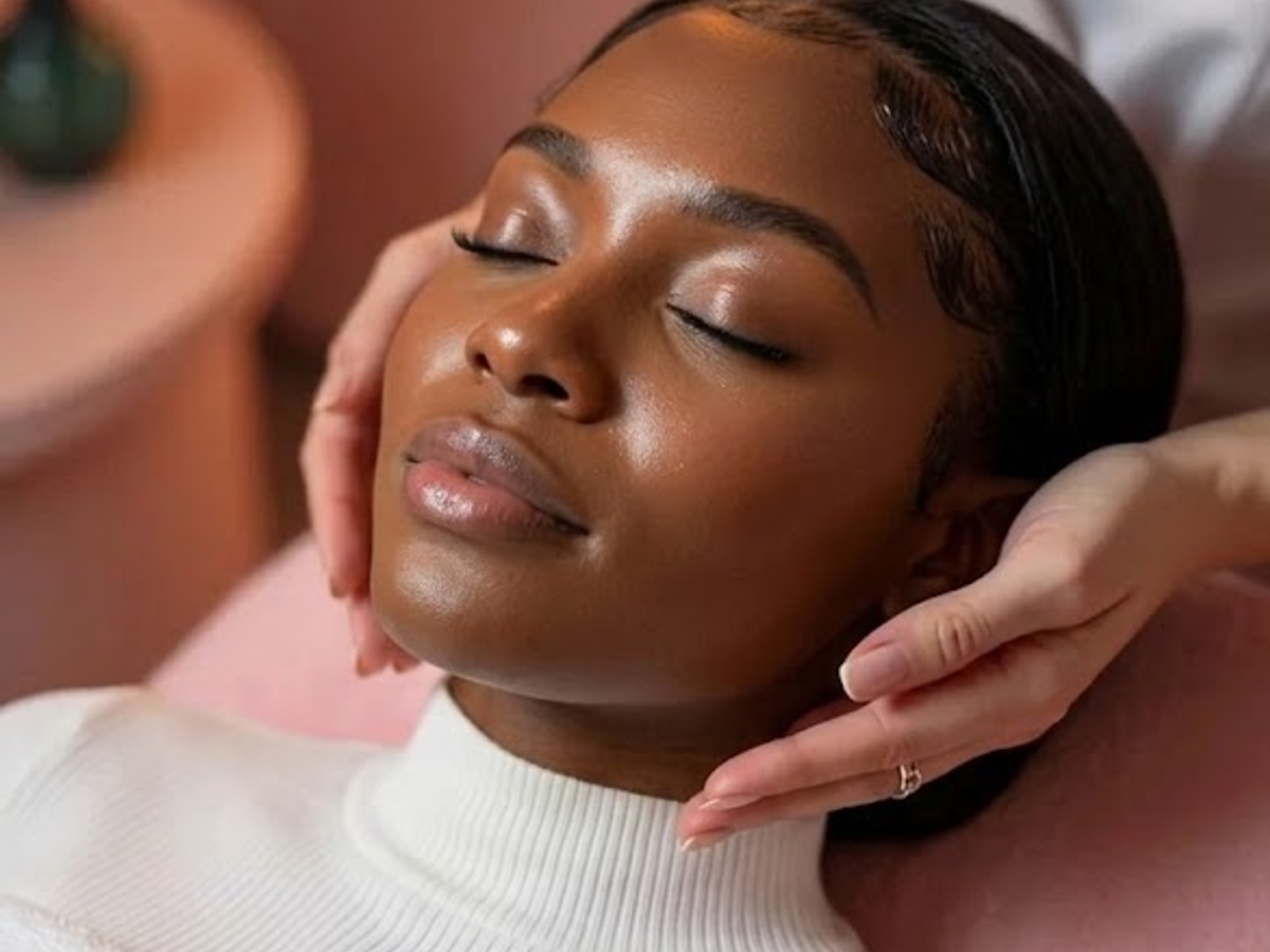 Woman relaxing during a facial massage treatment at NU Age Aesthetic clinic in Ajax