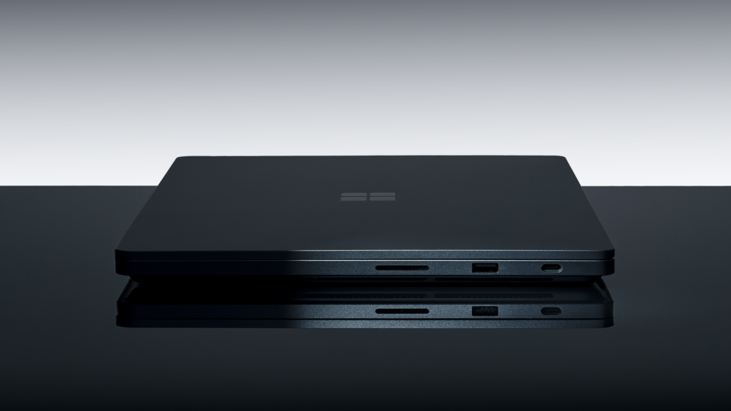 A closed Surface Laptop Ultra in Nightfall, with its side ports visible, in Microsoft’s official product photograph.