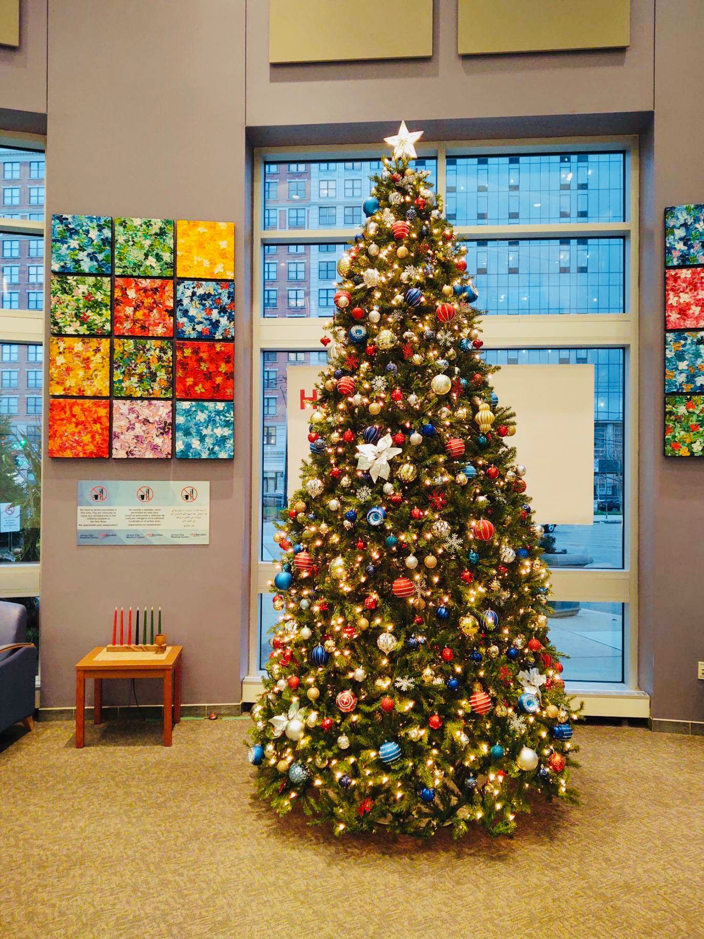 A decorated Christmas tree in a hospital lobby