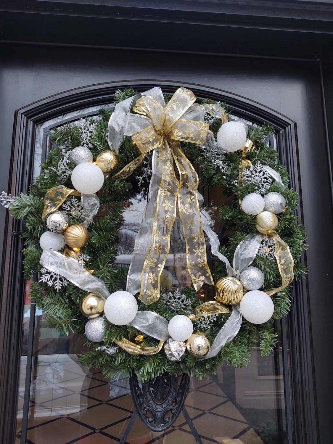 A Tinsel Treasures gold & silver pre-decorated wreath on front door