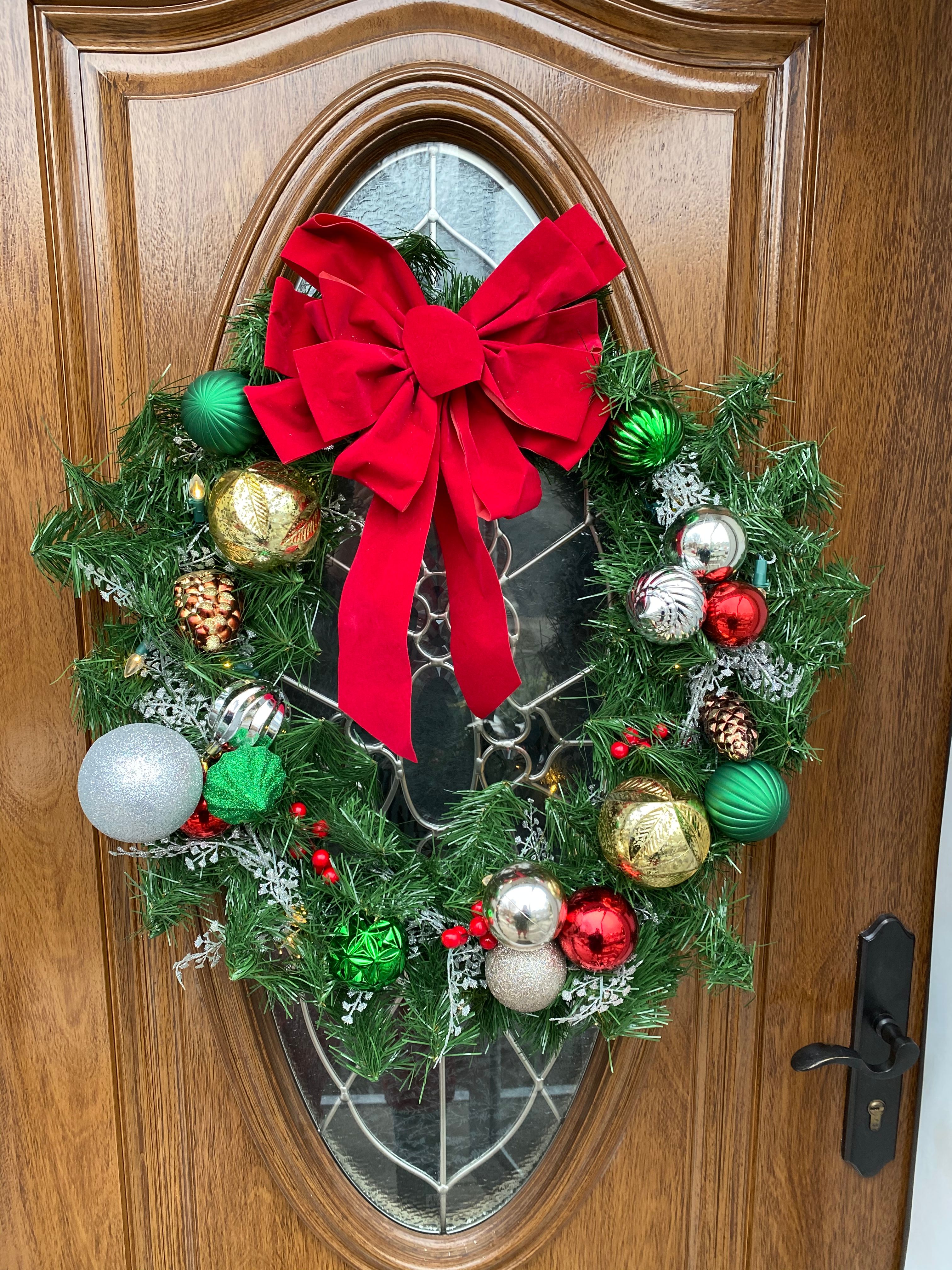 A decorated Christmas wreath on front door