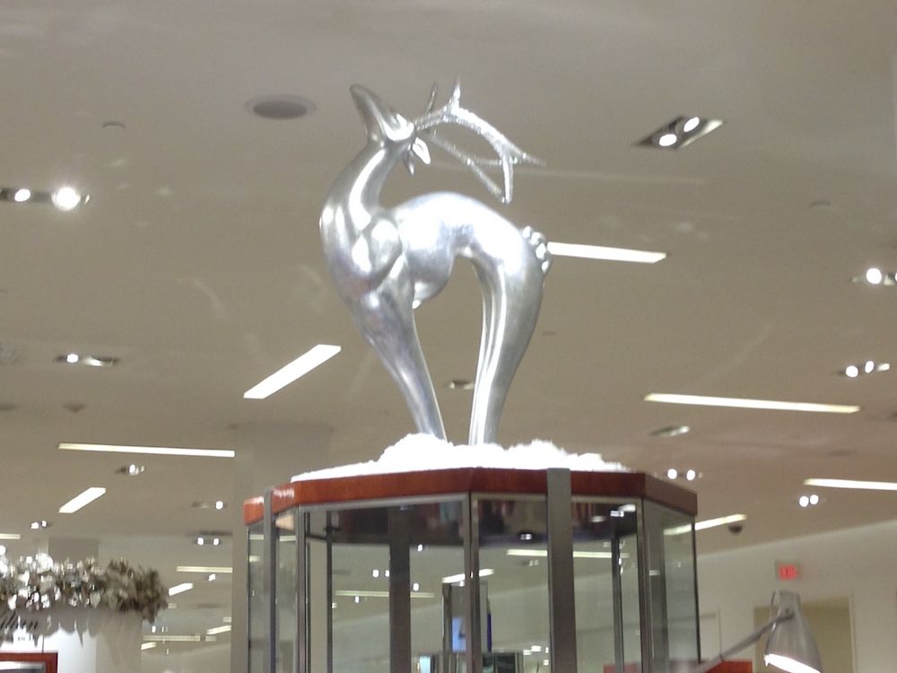 Oversized fiberglass art-deco deer in silver paint on display 