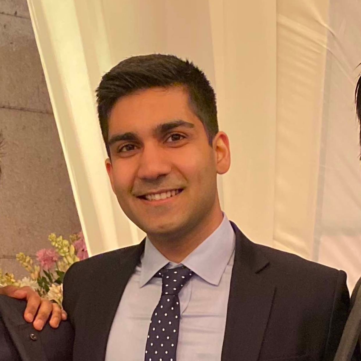 Nitish Kasturia, founder of EvoHire, smiling in a dark suit and patterned tie.