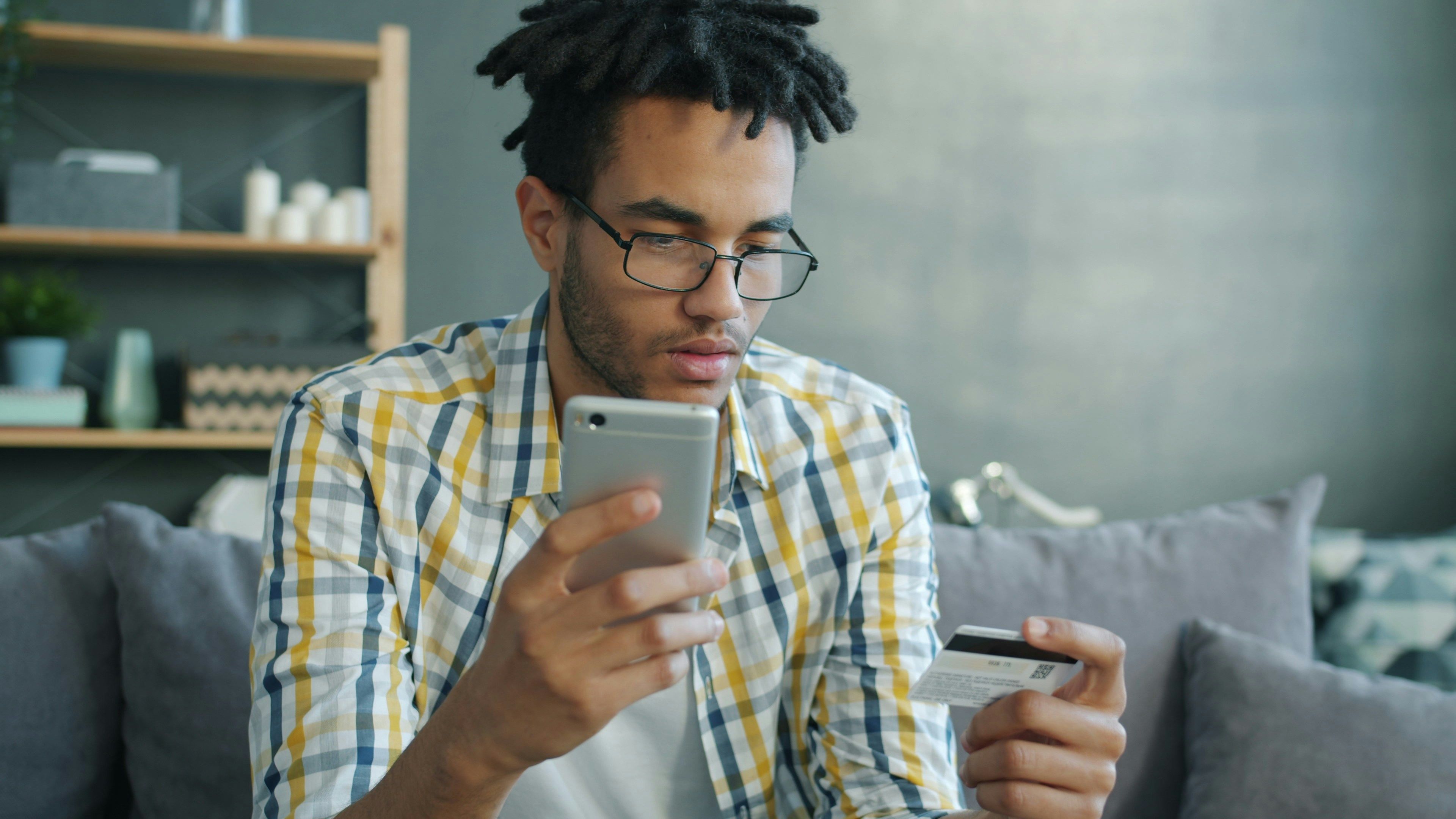 Martial arts student making a payment on his phone