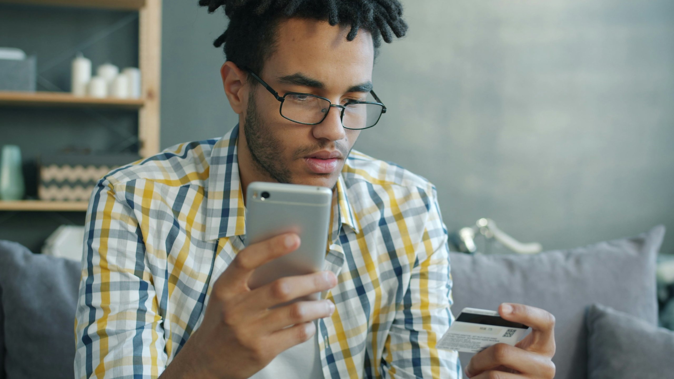 Martial arts student making a payment on his phone
